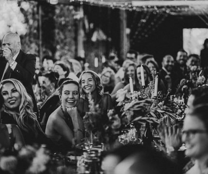 Black and white image of smiling wedding attendees. Wedding catering Melbourne