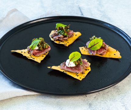 Premium Canapes with decadent lamb placed elegantly on a corn chip