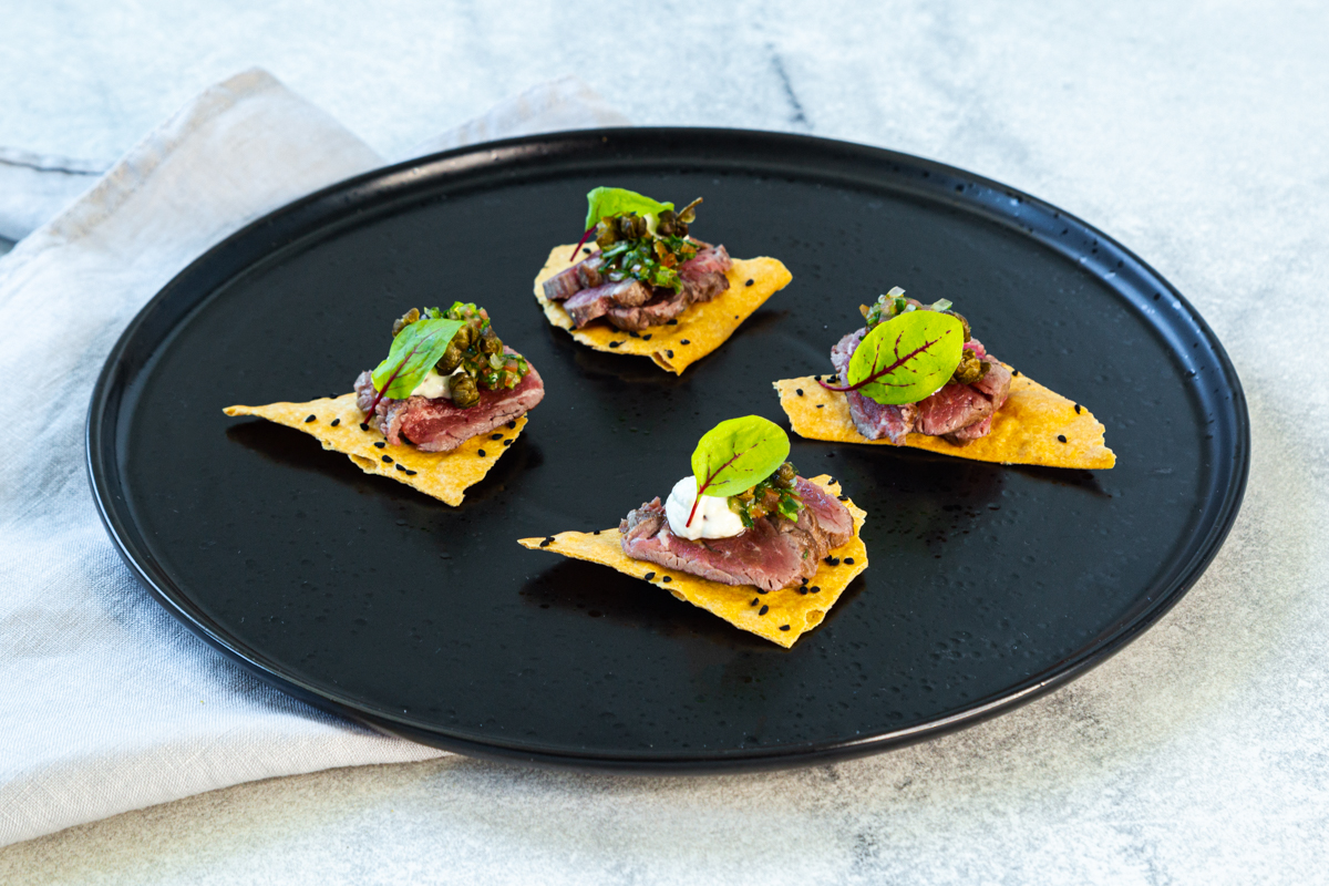 Premium Canapes with decadent lamb placed elegantly on a corn chip